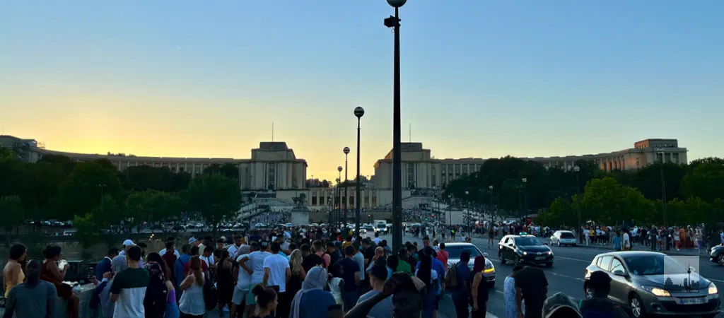 People are already waiting in front of the Palais du Trocadéro Palais du Trocadéro seen from under the Eiffel Tower over the Pont d'Iéna